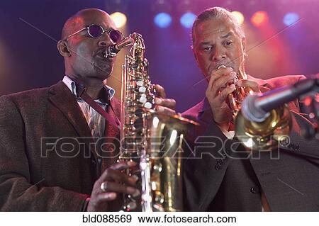 Stock Photo - Musicians playing in jazz band on stage. Fotosearch
