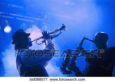 Stock Photo - Musicians playing in jazz band on stage. Fotosearch