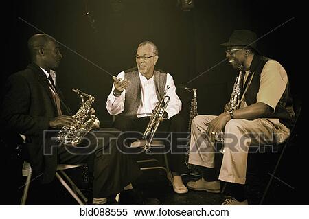 Stock Photography - Musicians playing in jazz band on stage. Fotosearch