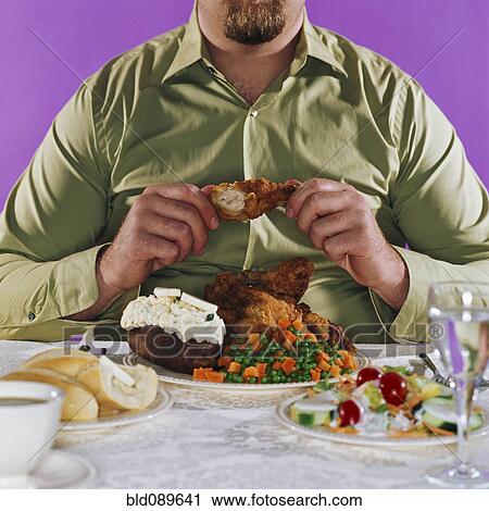 Overweight man eating fried chicken dinner View Large Photo Image Stock Image - Overweight man eating fried chicken dinner. Fotosearch