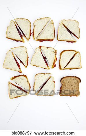 Stock Photo - Peanut butter and jelly sandwiches, one on whole wheat bread. Fotosearch