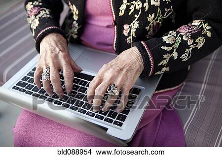 Picture - Senior Caucasian woman typing on laptop. Fotosearch