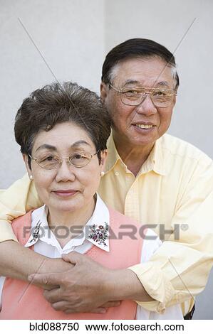 Stock Image - Senior Chinese couple hugging. Fotosearch