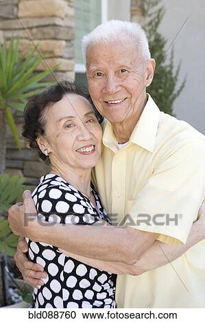 Stock Image - Senior Chinese couple hugging. Fotosearch