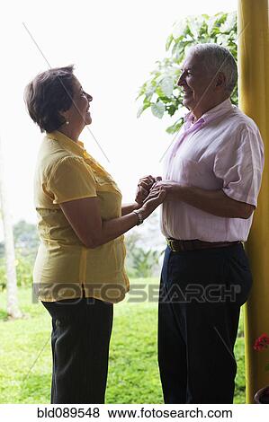 Stock Photo - Senior Hispanic couple holding hands. Fotosearch