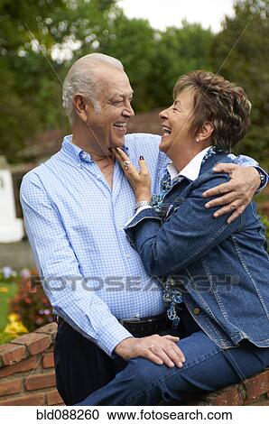 Stock Image - Senior Hispanic couple hugging. Fotosearch