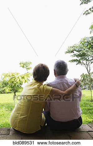 Senior Hispanic couple sitting outdoors together View Large Photo Image Stock Image - Senior Hispanic couple sitting outdoors together. Fotosearch