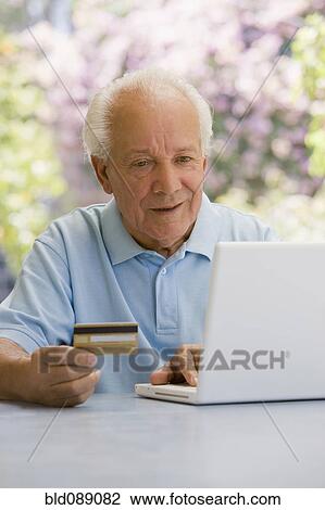 Senior Hispanic man shopping online with credit card View Large Photo Image Stock Image - Senior Hispanic man shopping online with credit card. Fotosearch