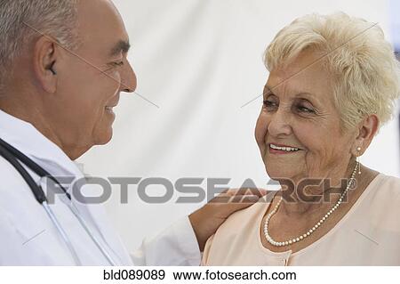 Senior woman talking with doctor View Large Photo Image Stock Photo - Senior woman talking with doctor. Fotosearch