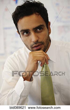 Serious businessman thinking View Large Photo Image Stock Image - Serious businessman thinking. Fotosearch