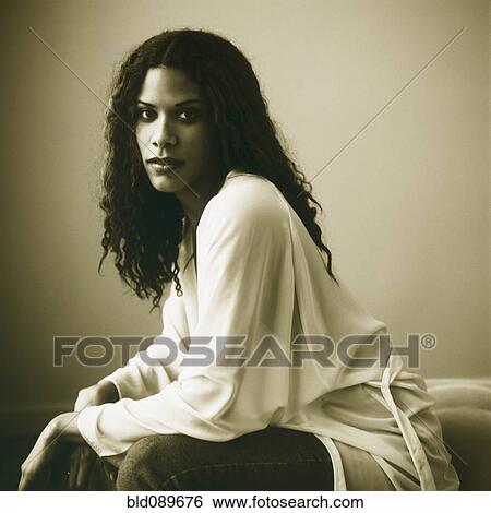 Serious woman sitting View Large Photo Image Stock Photograph - Serious woman sitting. Fotosearch