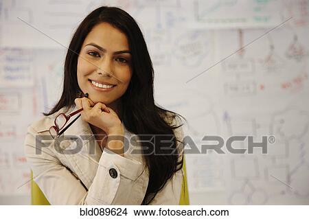 Smiling businesswoman in office View Large Photo Image Picture - Smiling businesswoman in office. Fotosearch