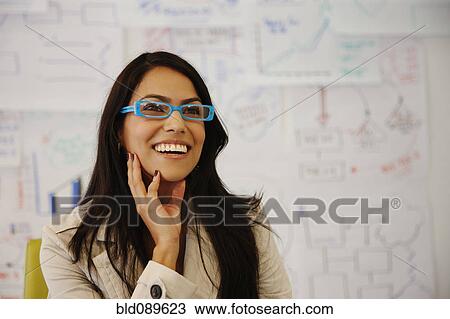 Stock Image - Smiling businesswoman in office. Fotosearch