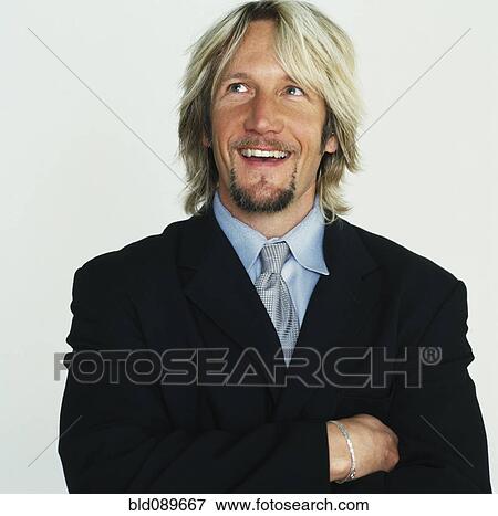Stock Photo - Smiling Caucasian businessman with arms crossed. Fotosearch