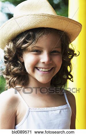 Stock Image - Smiling girl wearing hat. Fotosearch