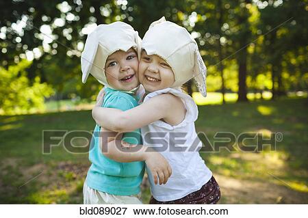 Smiling girls in mouse costume hugging View Large Photo Image Stock Photo - Smiling girls in mouse costume hugging. Fotosearch