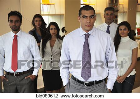 Smiling Hispanic business people standing together in office View Large Photo Image Stock Image - Smiling Hispanic business people standing together in office. Fotosearch