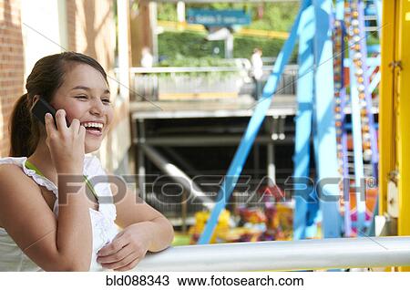 Smiling Hispanic girl talking on cell phone View Large Photo Image Stock Image - Smiling Hispanic girl talking on cell phone. Fotosearch