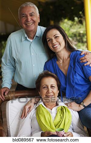 Stock Photo - Smiling Hispanic parents and daughter. Fotosearch