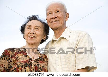 Stock Image - Smiling senior Chinese couple. Fotosearch