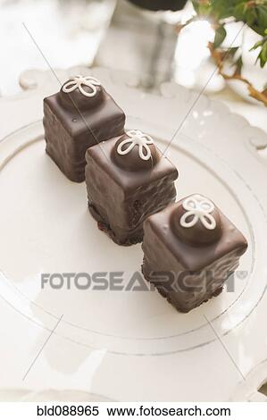 Three chocolate ganache petite cakes View Large Photo Image Stock Photography - Three chocolate ganache petite cakes. Fotosearch