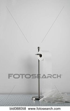 Stock Photo - Toilet paper spilling onto the floor. Fotosearch