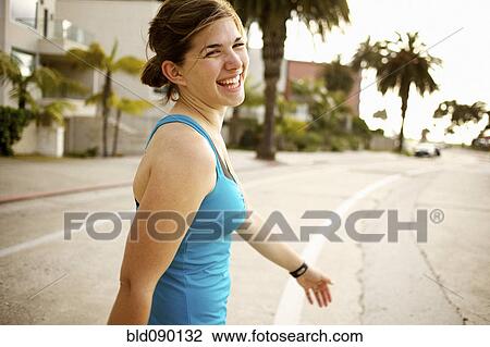 Stock Image - Athletic mixed race woman crossing street. Fotosearch