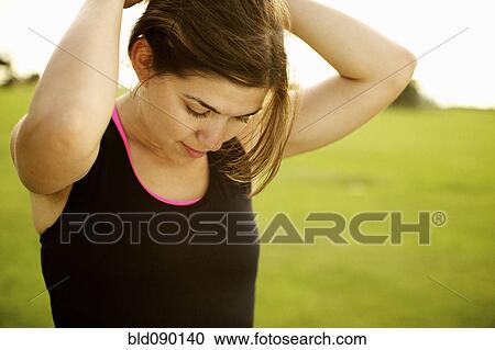 Stock Image - Athletic mixed race woman standing outdoors. Fotosearch
