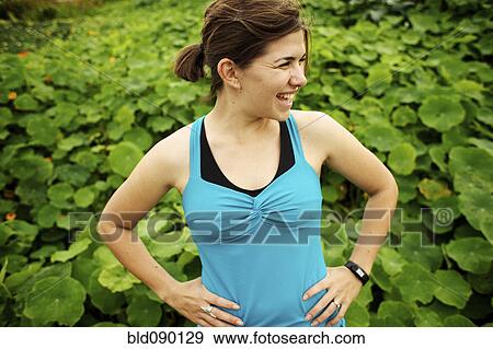 Stock Photo - Athletic mixed race woman standing outdoors. Fotosearch