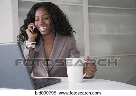 Black businesswoman with laptop talking on cell phone View Large Photo Image Stock Photography - Black businesswoman with laptop talking on cell phone. Fotosearch