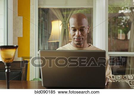 Black man using laptop View Large Photo Image Stock Photography - Black man using laptop. Fotosearch