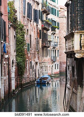 Stock Image - Boat moored in ornate canal. Fotosearch