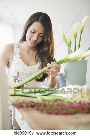 Stock Photo - Brazilian woman arranging flowers. Fotosearch