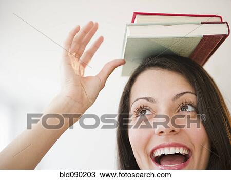 Brazilian woman balancing books on her head View Large Photo Image Stock Image - Brazilian woman balancing books on her head. Fotosearch