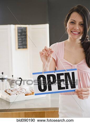 Brazilian woman holding open sign View Large Photo Image Stock Image - Brazilian woman holding open sign. Fotosearch