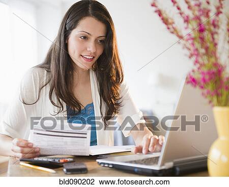 Brazilian woman paying bills online View Large Photo Image Stock Image - Brazilian woman paying bills online. Fotosearch