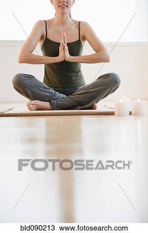 Stock Image - Brazilian woman practicing yoga. Fotosearch