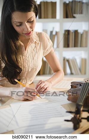 Brazilian woman writing music View Large Photo Image Stock Image - Brazilian woman writing music. Fotosearch