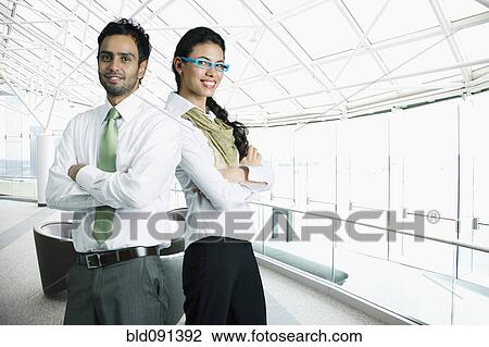Business people standing together in airport View Large Photo Image Stock Image - Business people standing together in airport. Fotosearch