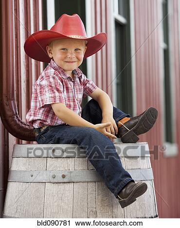 Caucasian cowboy sitting on barrel View Large Photo Image Stock Image - Caucasian cowboy sitting on barrel. Fotosearch
