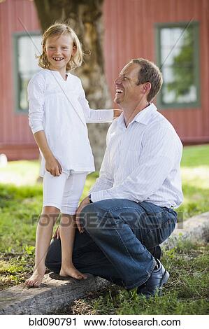 Stock Image - Caucasian father and daughter outdoors together. Fotosearch