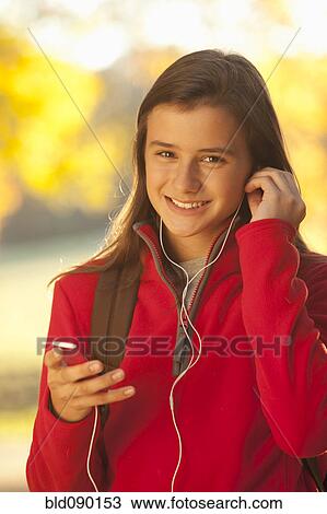 Caucasian girl listening to mp3 player View Large Photo Image Stock Image - Caucasian girl listening to mp3 player. Fotosearch