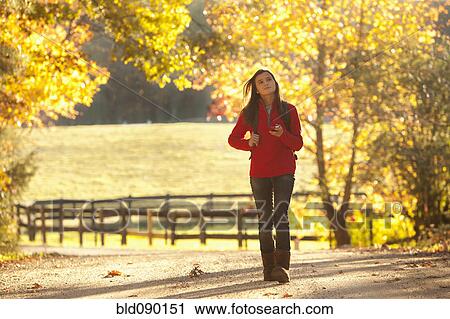 Caucasian girl walking on road in countryside View Large Photo Image Stock Image - Caucasian girl walking on road in countryside. Fotosearch