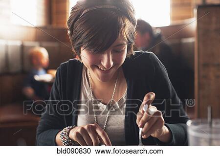 Stock Image - Caucasian teenager eating in restaurant. Fotosearch