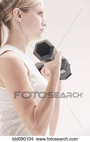 Picture - Caucasian woman exercising with dumbbells. Fotosearch