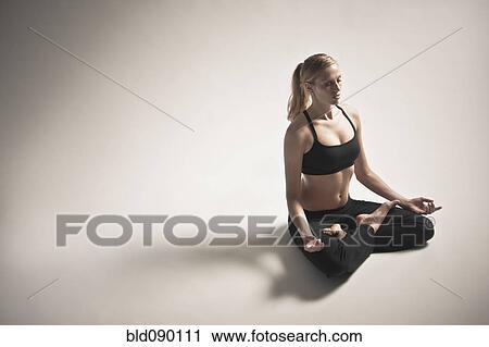 Stock Image - Caucasian woman practicing yoga. Fotosearch