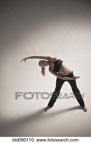 Caucasian woman stretching and exercising View Large Photo Image Stock Image - Caucasian woman stretching and exercising. Fotosearch