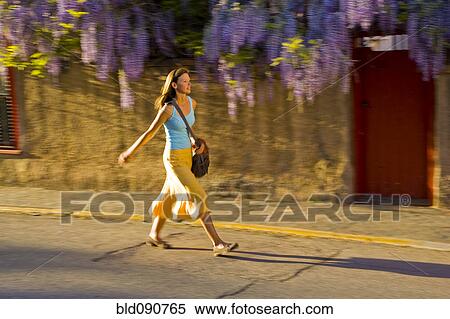 Caucasian woman walking on street View Large Photo Image Stock Photography - Caucasian woman walking on street. Fotosearch