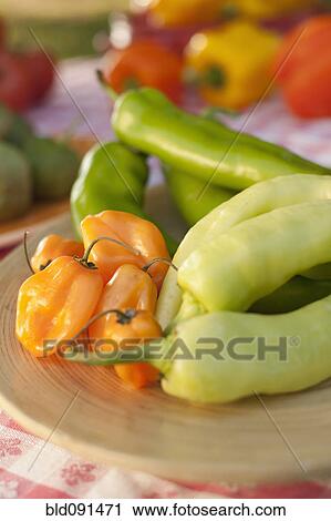 Stock Image - Close up of peppers on plate. Fotosearch