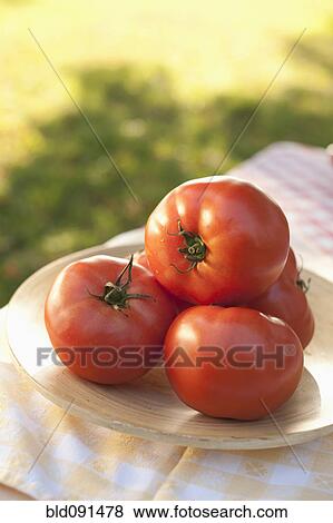 Stock Photo - Close up of tomatoes on plate. Fotosearch